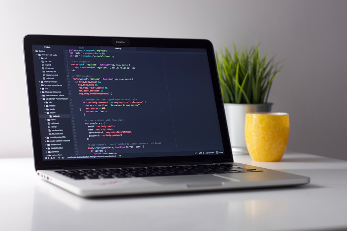 Laptop with code editor showing syntax-highlighted programming code