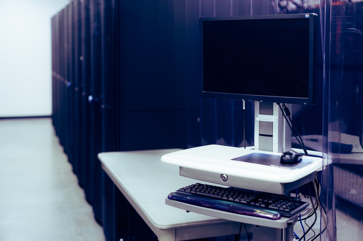 Data center with server racks and a workstation monitor
